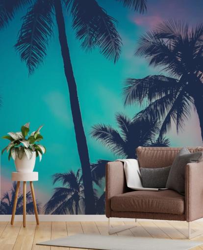 sagome di palma nera contro carta da parati cieli blu, rosa e arancione