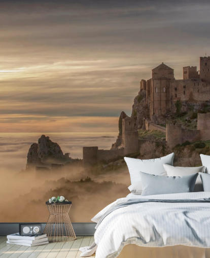 spanish castle on mountaintop above mist mountains wallpaper