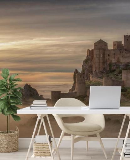 spanish castle on mountaintop above mist mountains wallpaper