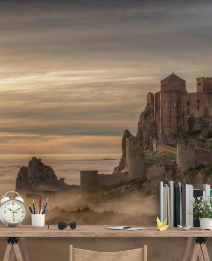 spanish castle on mountaintop above mist mountains wallpaper