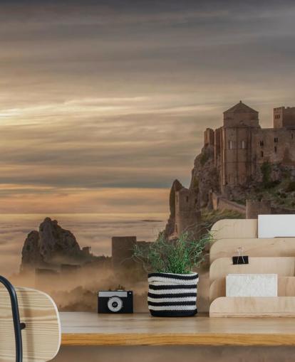 spanish castle on mountaintop above mist mountains wallpaper