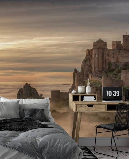 spanish castle on mountaintop above mist mountains wallpaper