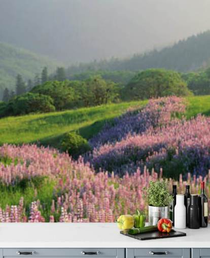 light purple and pink wild flowers in field with green hills wallpaper
