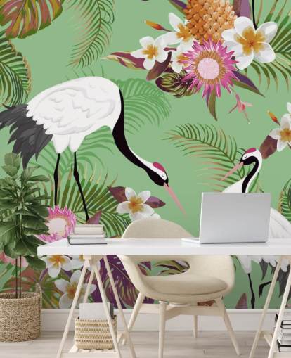 dois guindastes com folhagem tropical e papel de parede de fundo verde