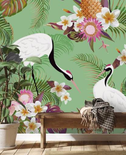 dois guindastes com folhagem tropical e papel de parede de fundo verde