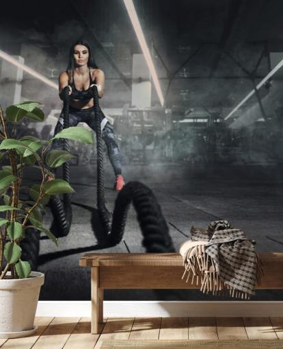 Powerful muscular woman fitness trainer do battle workout with ropes mural Powerful muscular woman fitness trainer do battle workout with ropes mural