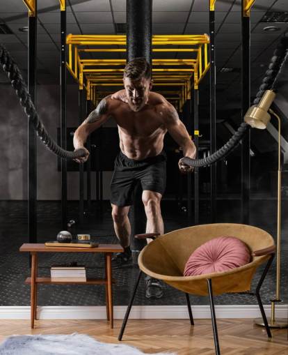 dark gym with man with heavy ropes wallpaper