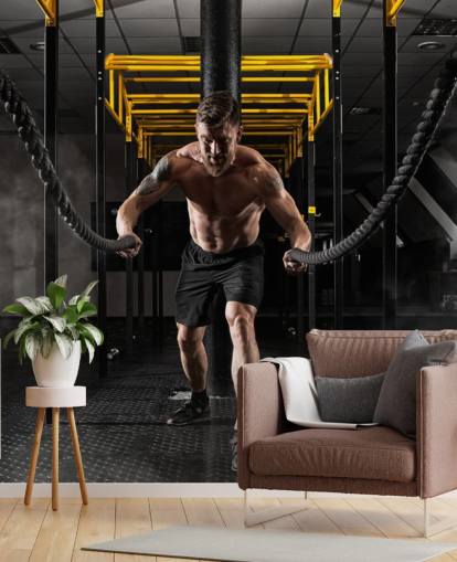 dark gym with man with heavy ropes wallpaper