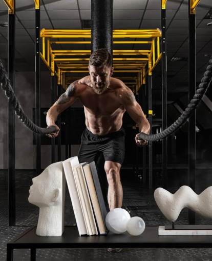 dark gym with man with heavy ropes wallpaper