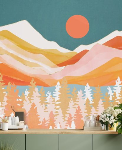 Orange and yellow mountains and forest with a teal sky and orange sun