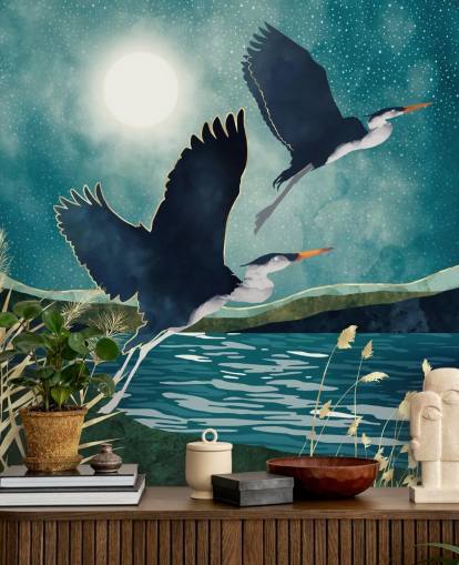 Navy herons flying over a blue river with a turquiose sky