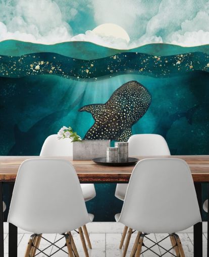 Océano azul oscuro con un tiburón ballena dorado y siluetas azules distantes 