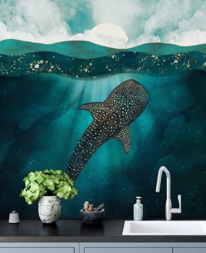 Dark blue ocean with a gold whale shark and distant blue silhouettes 