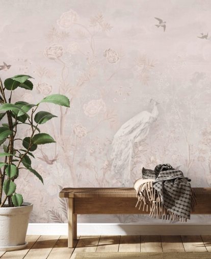 Light pink faded vintage wallpaper in a chinoiserie style with soft grownig vines and white crane birds and peacocks