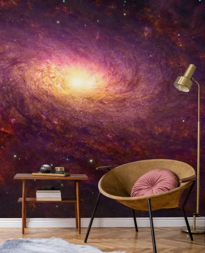 Dark purple swirling galaxy with red swirls and stars with a bright center wallpaper