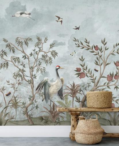 Blue, watercolour sky with growing trees and vines with dark pink roses, flying birds and white and blue egret birds in a chinoiserie style wallpaper