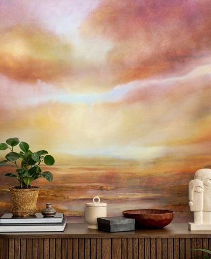 Abstract painting of a yellow and pink landsape with the sun shining through the clouds
