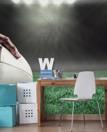 papel de parede de rugby personalizado verde e preto chamado Hand on Rugby Ball para quartos infantis