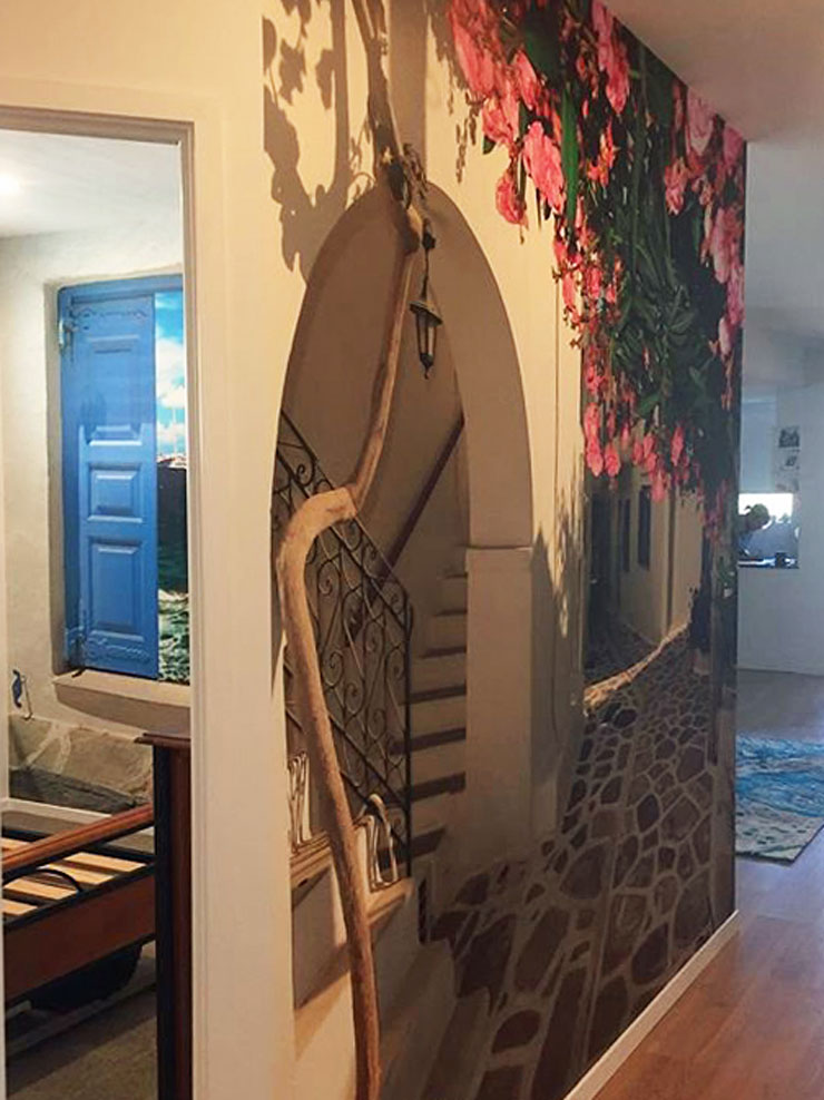 greek island white house with pink flowers wallpaper in homely hallway
