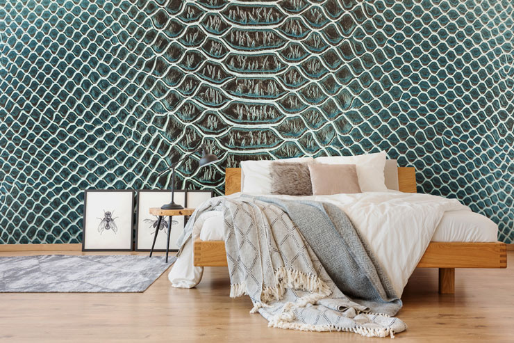 green lizard print wallpaper in trendy master bedroom