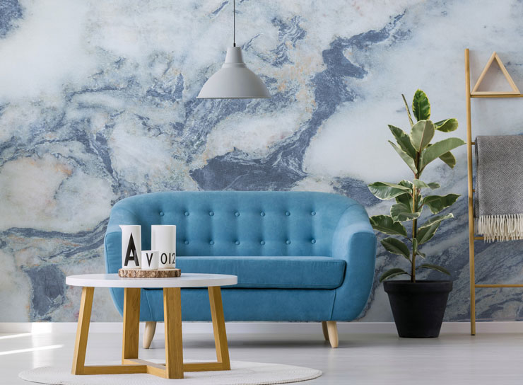 blue sofa with blue and white marble feature wall