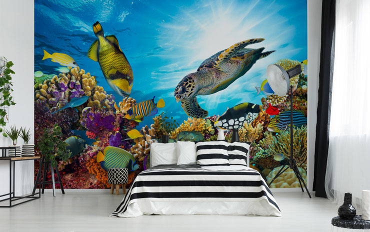 fish, turtle and coral wallpaper in open loft apartment with stripey black and white bed