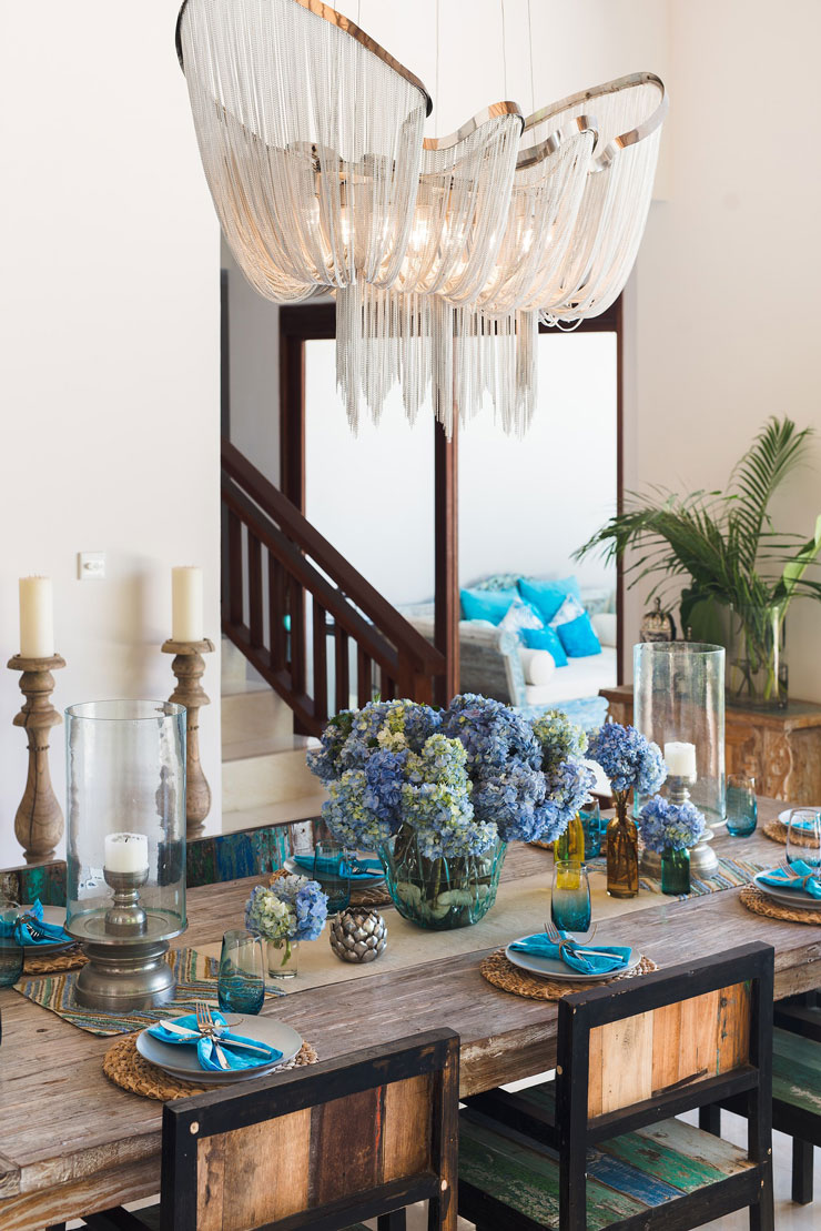 beautiful flowing crystal chandelier in blue themed dining room