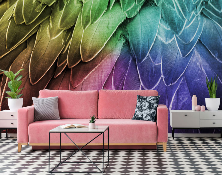 pink velvet sofa with black and white floor with rainbow feather wallpaper in background
