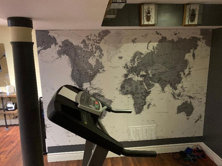 grey illustrated world map in home gym with wall divider