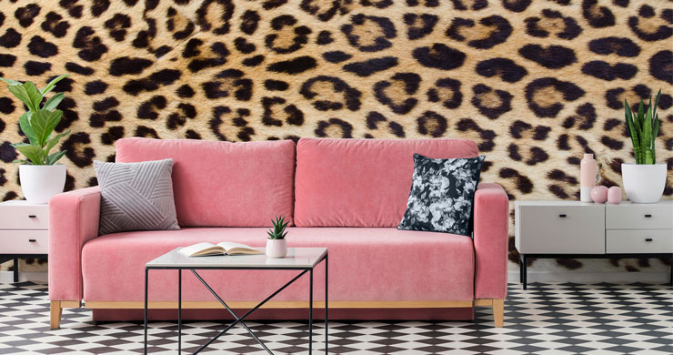 jaguar print wallpaper with hot pink sofa and patterned decor