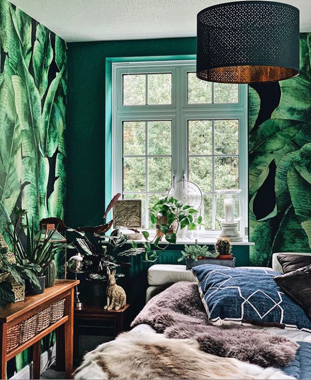 dark palm leaf wallpaper in bedroom with maximalist decor