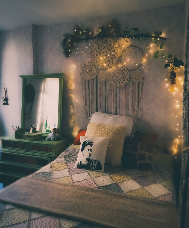 dark country bedroom with dream catchers, greenery and fairy lights