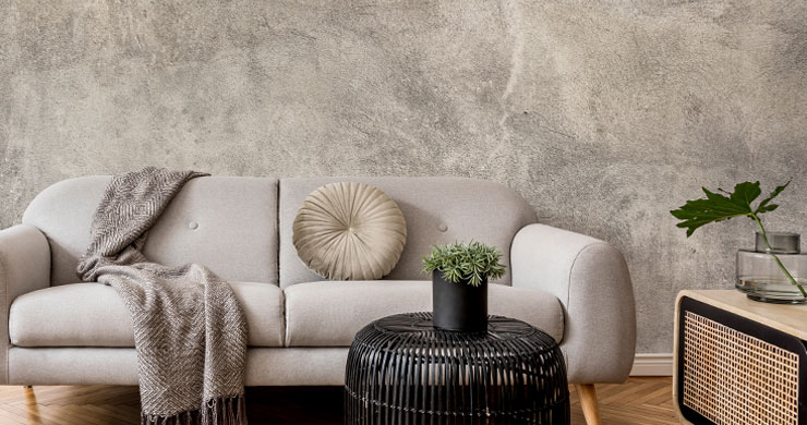 grey plaster wallpaper with elegant grey sofa, throw and cushion for perfect timeless interiors