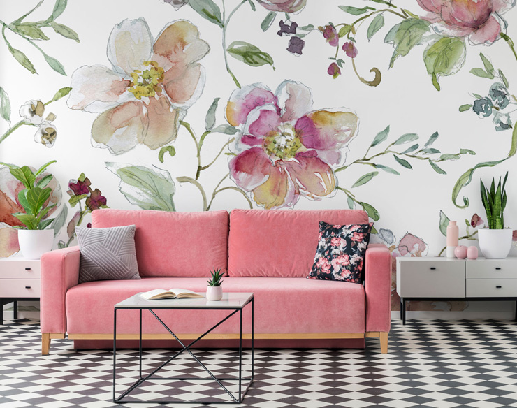white background and large pink floral pattern in lounge with bright pink sofa and black and white tiled floor