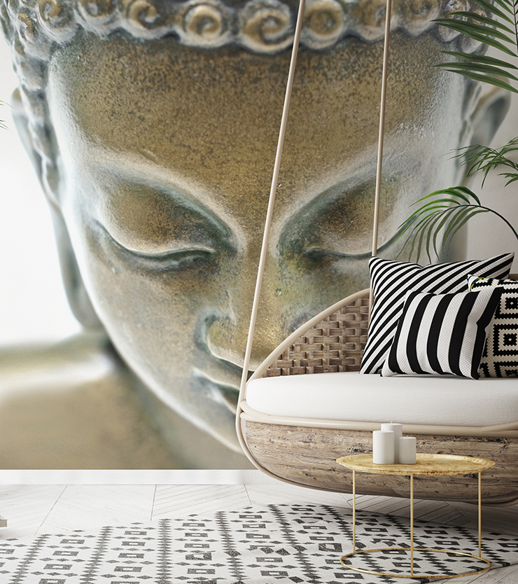 close up of bronze buddha statue wallpaper in lounge with rattan swinging chair