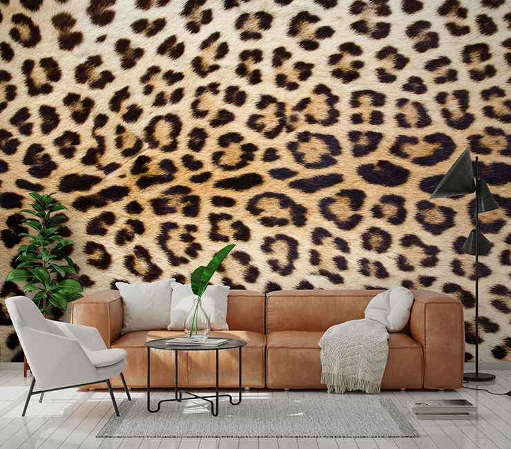 close up photo of jaguar print wallpaper in lounge with brown leather sofa