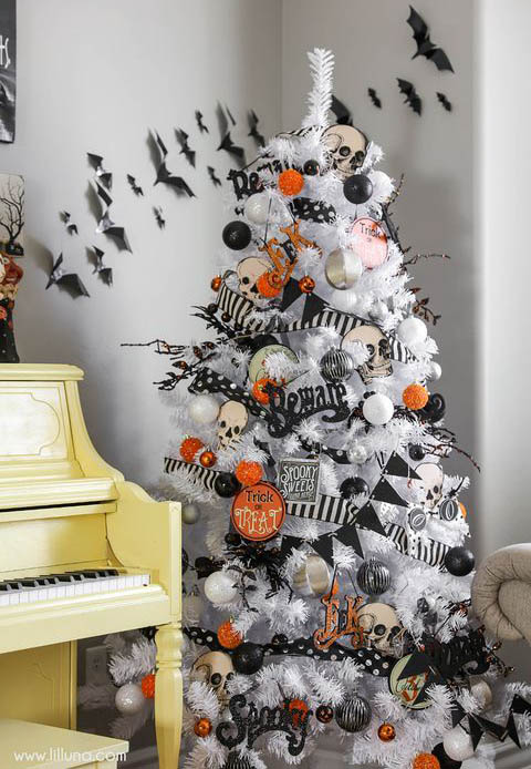 white christmas tree with black and orange halloween decorations