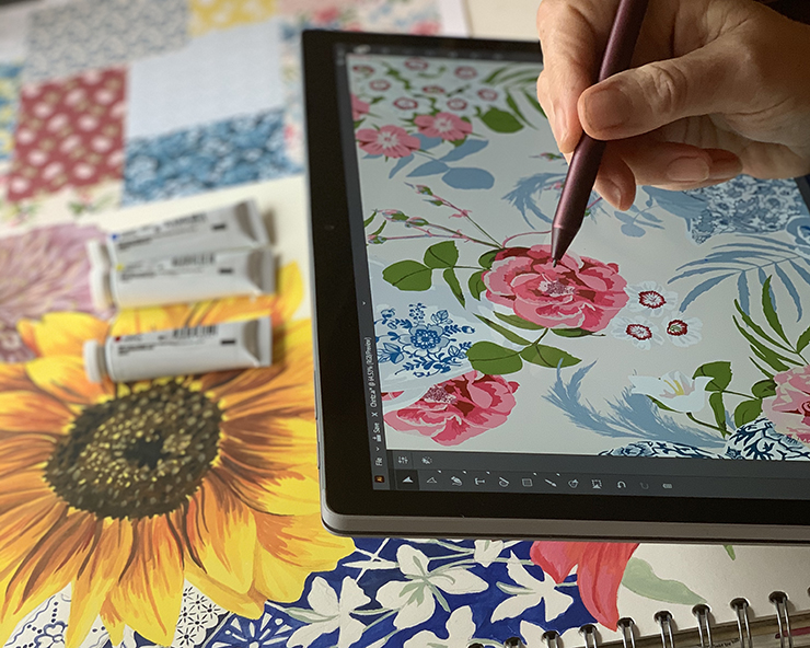artist's hand drawing a floral pattern on an iPad
