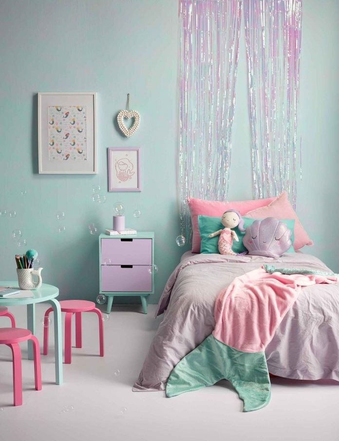 pastel pink and purple child's mermaid bedroom with sparkly tinsel curtain above bed