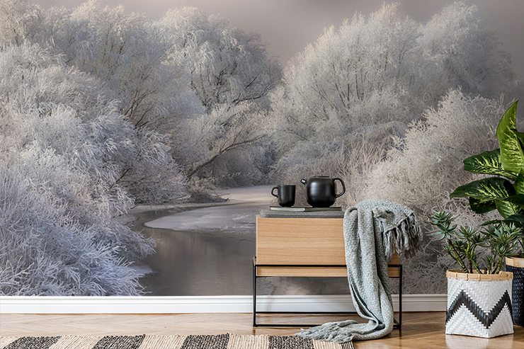 frosty forest with river running through wall mural in cosy lounge