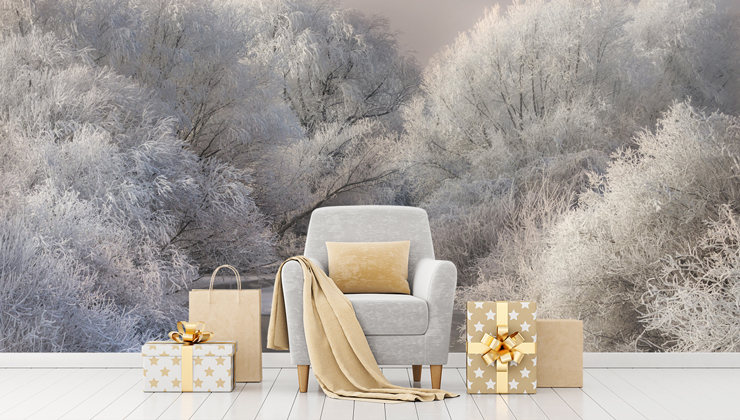 grey armchair with gold cushion and golden wrapped presents with snowy forest wallpaper