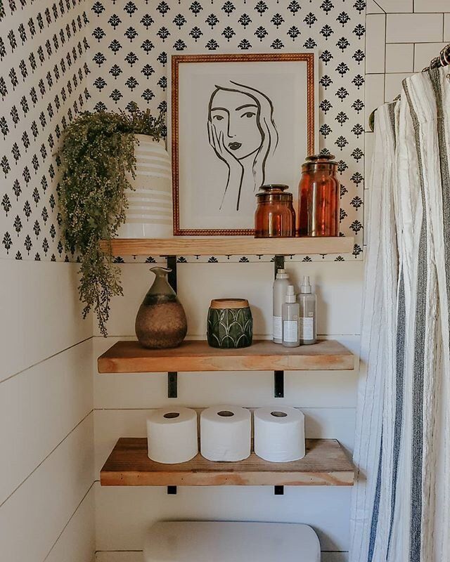 light natural wooden floating shelves in black and white bedroom