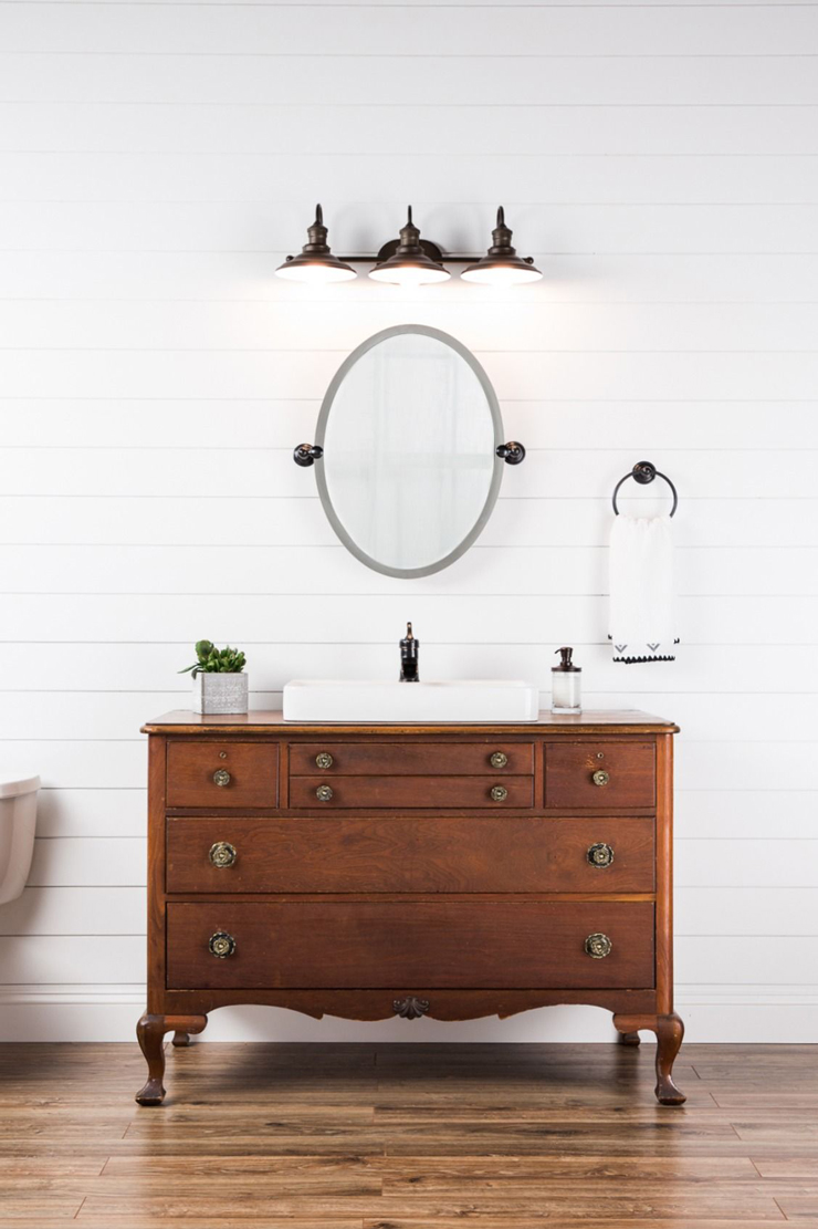 walnut colored wooden vanity faucet in white large bathroom
