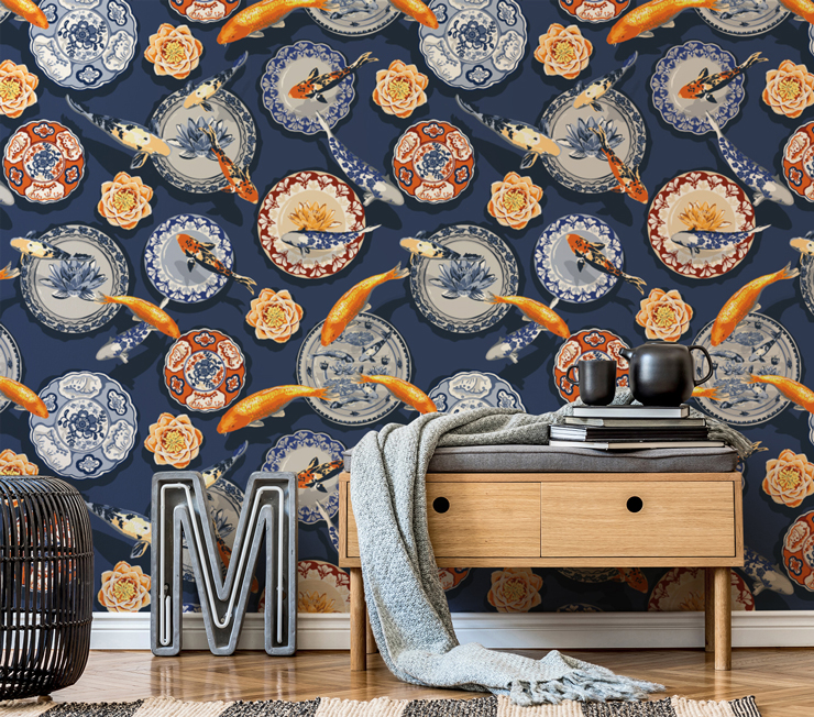 navy wallpaper with oriental plates and orange koi fish in room with sidetable and grey blanket