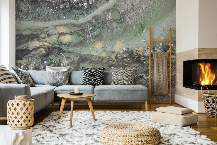 room with blue-green geode feature wall with L-shaped grey sofa and big fluffy rug
