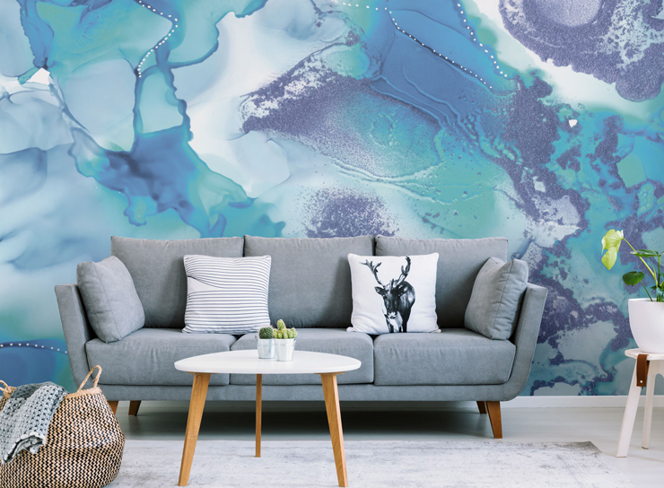 blue and white abstract art wallpaper in lounge with grey sofa