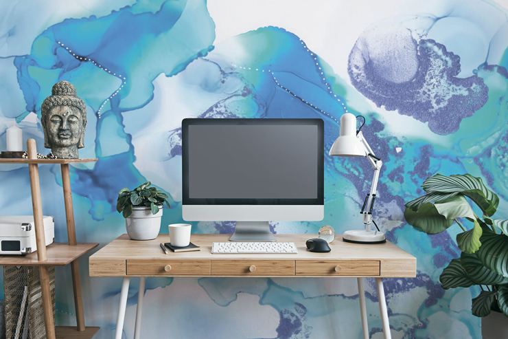 blue and white marble effect wallpaper in calm home office with wooden desk, buddha head and green plants