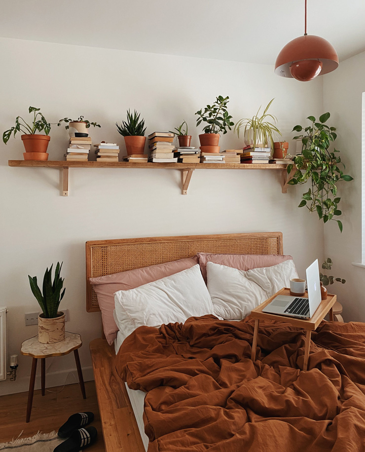 white and terracotta boho bedroom with green plants