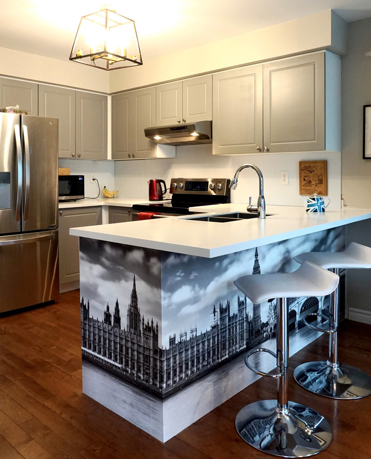 grey and white kitchen with houses of parliament black and white wallpaper on breakfast bar