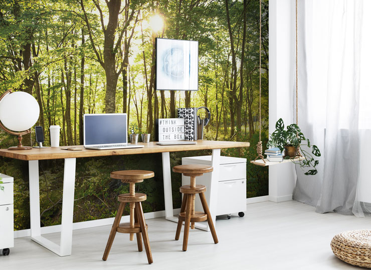 green forest wall mural in home office with wooden desk and stools